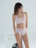 Woman wearing NuCloud Original Mid-Rise Brief in soft, stretchy fabric with raw-cut edges and full coverage.
