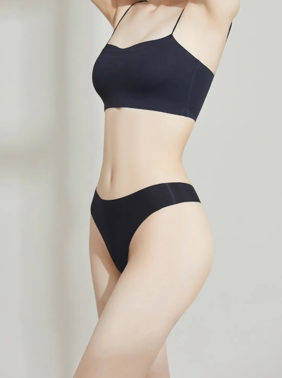 Person wearing a NuCloud Original Thong Black on a plain background