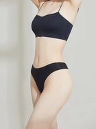 Person wearing a NuCloud Original Thong Black on a plain background