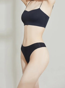 Person wearing a NuCloud Original Thong Black on a plain background