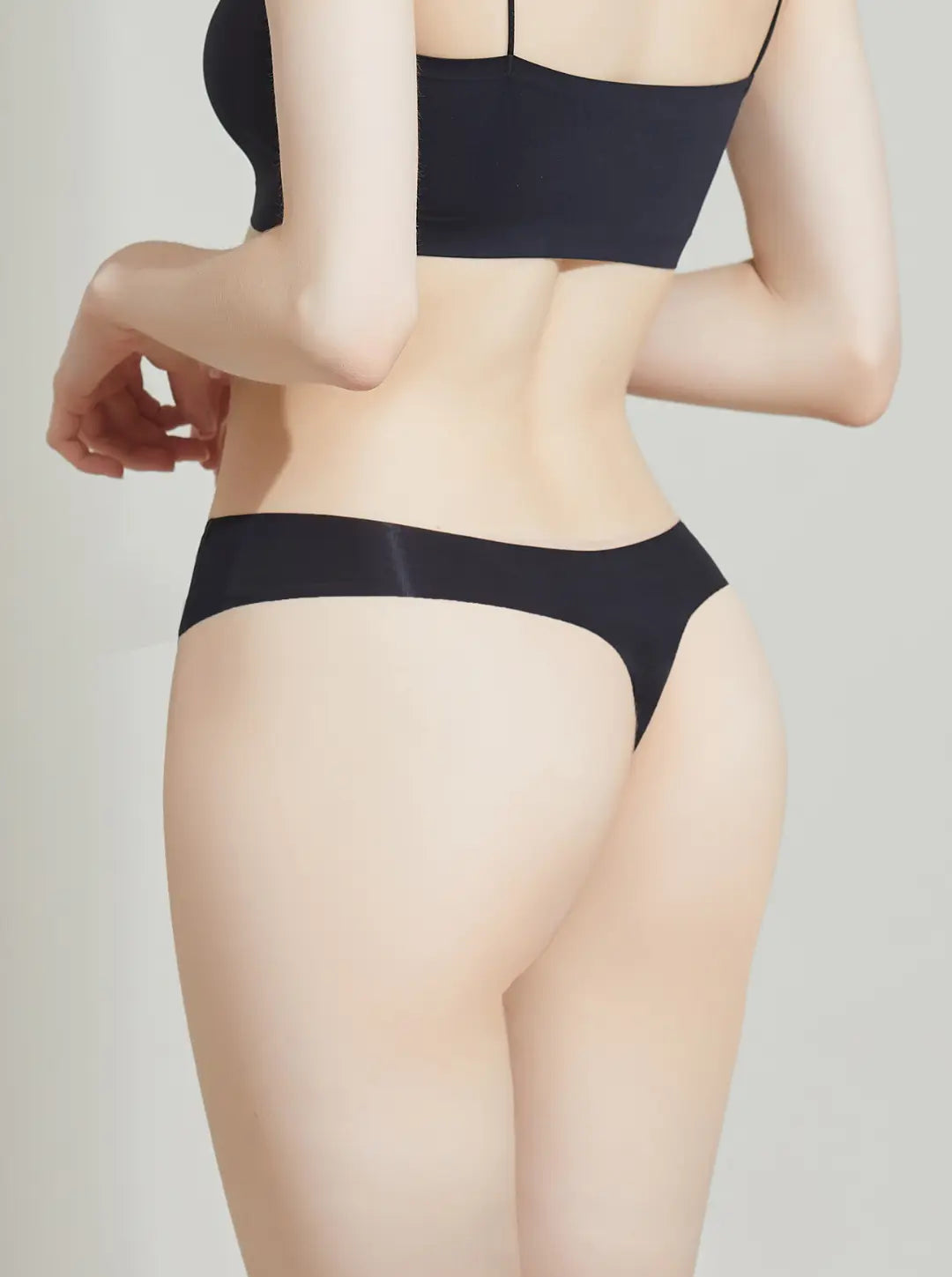 Person wearing a NuCloud Original Thong Black set on a plain background