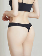 Person wearing a NuCloud Original Thong Black set on a plain background