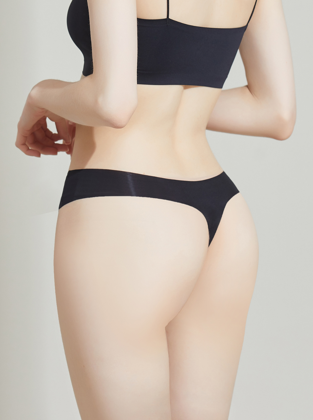 Person wearing a NuCloud Original Thong Black set on a plain background