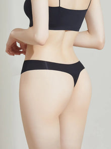 Person wearing a NuCloud Original thong set on a plain background
