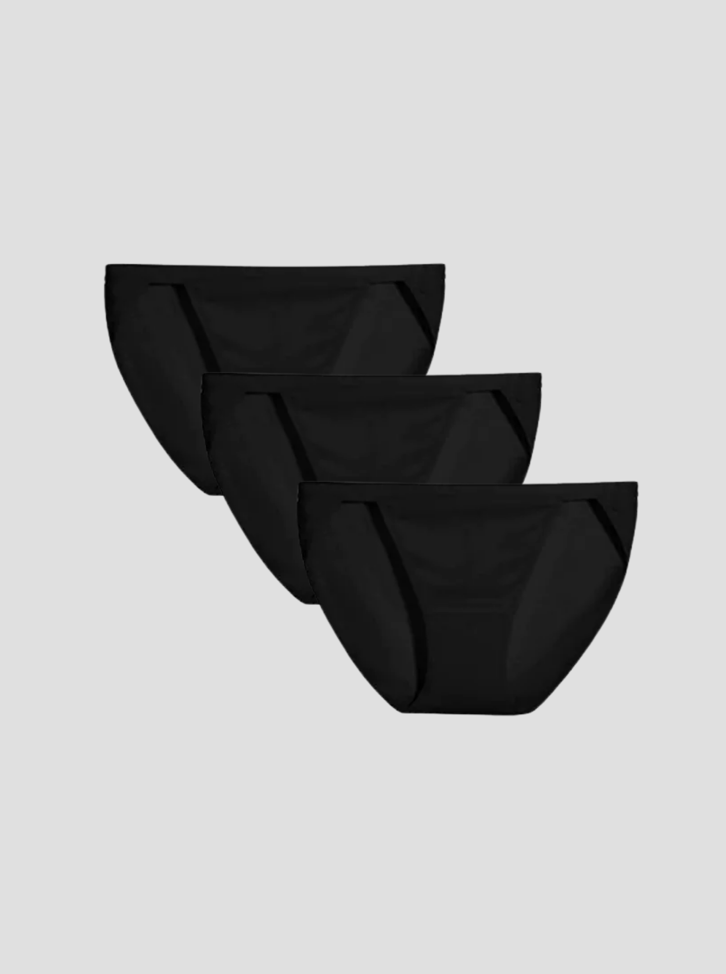 Set of three black NuSoft String Bikini briefs with high-cut legs and shiny elastic waistbands on a gray background