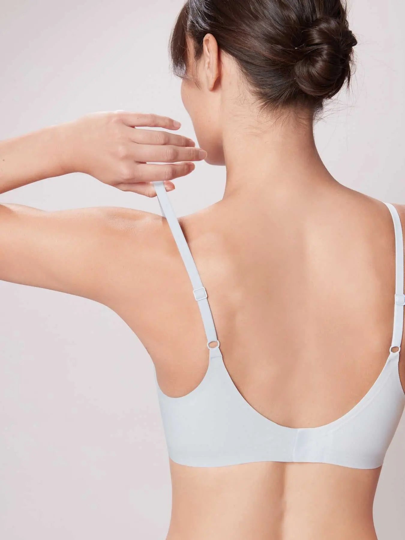 Woman wearing a Wireless Soft Stay-Put Bra White against a plain background